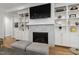 Cozy living room featuring a fireplace with a tiled surround and built-in shelving on either side, creating a focal point at 911 Canterbury Rd, Raleigh, NC 27607