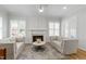 Elegant living room with plush sofas, fireplace, and large windows offering natural light and a comfortable gathering space at 911 Canterbury Rd, Raleigh, NC 27607