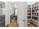 Walk-in pantry with custom shelving located just off the kitchen, offering ample storage at 911 Canterbury Rd, Raleigh, NC 27607