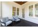 A lovely outdoor patio with whitewashed brick, adorned with rocking chairs for comfortable relaxation and outdoor enjoyment at 911 Canterbury Rd, Raleigh, NC 27607