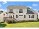 Rear exterior of home with large windows, a wooden deck, and a spacious lawn at 9112 Mission Hills Ct, Raleigh, NC 27617