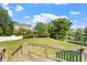 View of a spacious backyard featuring a wooden deck and mature trees at 9112 Mission Hills Ct, Raleigh, NC 27617