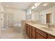 Bathroom with double sink vanity, framed mirror, shower, and soaking tub at 9112 Mission Hills Ct, Raleigh, NC 27617