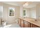 The bright bathroom features a double vanity and large mirror and window at 9112 Mission Hills Ct, Raleigh, NC 27617