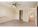 This is a bright bedroom featuring neutral walls, carpet flooring and ceiling fan at 9112 Mission Hills Ct, Raleigh, NC 27617