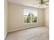 Bedroom with neutral walls and carpet, featuring a window with an outdoor view at 9112 Mission Hills Ct, Raleigh, NC 27617