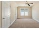 Large bedroom with a ceiling fan, one window, neutral walls, carpet floors and two closets at 9112 Mission Hills Ct, Raleigh, NC 27617
