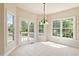 Bright breakfast nook featuring tile floor and windows overlooking a green, outdoor view at 9112 Mission Hills Ct, Raleigh, NC 27617