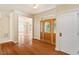 Inviting foyer featuring gleaming hardwood floors, an elegant front door, and an arched doorway leading to the dining room at 9112 Mission Hills Ct, Raleigh, NC 27617