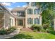 Beautiful brick home featuring well-manicured landscaping, a covered porch, and decorative green shutters at 9112 Mission Hills Ct, Raleigh, NC 27617