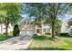 Charming brick home with a two-car garage, green shutters, and a well-maintained front yard at 9112 Mission Hills Ct, Raleigh, NC 27617
