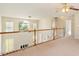 View of the upper hallway with multiple rooms and a window for lots of light at 9112 Mission Hills Ct, Raleigh, NC 27617