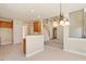 Open kitchen layout with eat-in bar, tile flooring, and view of living area and stairway at 9112 Mission Hills Ct, Raleigh, NC 27617