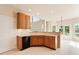 Bright kitchen features tiled floors, natural wood cabinetry, and a black dishwasher at 9112 Mission Hills Ct, Raleigh, NC 27617