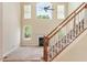 Open living room with a cozy fireplace, abundant natural light from large windows, and a staircase at 9112 Mission Hills Ct, Raleigh, NC 27617