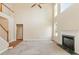 High-ceiling living room with fireplace, carpeted floor, and natural light from large windows at 9112 Mission Hills Ct, Raleigh, NC 27617
