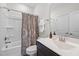 Clean bathroom features a shower with curtain, white sink and cabinet, and coordinating fixtures at 1010 Sandbar Ln, Durham, NC 27703
