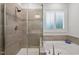 Bathroom featuring a tiled shower and a soaking tub with natural light at 1010 Sandbar Ln, Durham, NC 27703