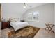 Relaxing bedroom with a large window, bedside tables, and a decorative area rug at 1010 Sandbar Ln, Durham, NC 27703