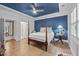 Bedroom featuring four-poster bed, stylish decor, and hardwood flooring at 1010 Sandbar Ln, Durham, NC 27703