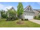 Charming one-story home featuring gray siding, a two-car garage, and manicured landscaping at 1010 Sandbar Ln, Durham, NC 27703