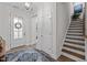 Welcoming foyer with hardwood floors, staircase, and a view into other rooms of the home at 1010 Sandbar Ln, Durham, NC 27703