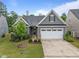 Charming single-story home with a well-manicured lawn, two car garage, and neutral gray siding at 1010 Sandbar Ln, Durham, NC 27703