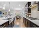 Modern kitchen featuring dark cabinetry, stainless steel appliances, and a large island at 1010 Sandbar Ln, Durham, NC 27703