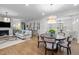Bright living room with fireplace, large windows, and hardwood floors at 1010 Sandbar Ln, Durham, NC 27703