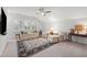 Bright living room with large windows, comfortable seating, and a decorative area rug at 1010 Sandbar Ln, Durham, NC 27703