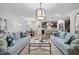 Bright living room featuring hardwood floors, neutral furniture, and a view into the kitchen at 1010 Sandbar Ln, Durham, NC 27703