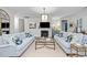 Cozy living room with a fireplace, comfortable seating, and elegant decor at 1010 Sandbar Ln, Durham, NC 27703