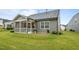 View of the home's backyard, featuring a cozy screened-in porch and a small patio at 1010 Sandbar Ln, Durham, NC 27703