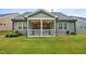 The backyard features a screened porch and lush green grass at 1010 Sandbar Ln, Durham, NC 27703