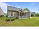 The backyard offers a screened porch and well-maintained landscaping at 1010 Sandbar Ln, Durham, NC 27703