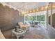 Inviting screened-in porch featuring wicker furniture, a ceiling fan and a decorative chandelier at 1010 Sandbar Ln, Durham, NC 27703