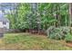 Spacious backyard framed by lush trees and wooden fence at 103 Kylie Savannah Ct, Cary, NC 27511