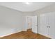 Bedroom with hardwood floors, neutral walls, and a view of the hallway at 103 Kylie Savannah Ct, Cary, NC 27511