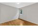 Cozy bedroom featuring hardwood floors and a window with a woven shade at 103 Kylie Savannah Ct, Cary, NC 27511