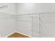 Walk-in closet featuring white wire shelving and hardwood floors at 103 Kylie Savannah Ct, Cary, NC 27511