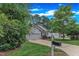 Exterior shot showcasing the well-kept lawn and mature trees surrounding the property at 103 Kylie Savannah Ct, Cary, NC 27511