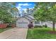 Inviting exterior with a lush front yard and driveway leading to the garage at 103 Kylie Savannah Ct, Cary, NC 27511