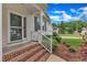 Welcoming front porch with brick steps and views of landscaped front yard at 103 Kylie Savannah Ct, Cary, NC 27511