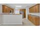 Kitchen with stainless steel refrigerator, light wood cabinets, and ample counter space with room to eat at 103 Kylie Savannah Ct, Cary, NC 27511