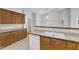 Traditional kitchen featuring wooden cabinets, white appliances, and a double-basin sink at 103 Kylie Savannah Ct, Cary, NC 27511