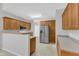 Well-lit kitchen with stainless steel refrigerator, microwave and light wood cabinets offering plenty of storage at 103 Kylie Savannah Ct, Cary, NC 27511