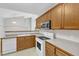 Bright kitchen featuring stainless steel refrigerator and oak cabinets with modern appliances and fixtures at 103 Kylie Savannah Ct, Cary, NC 27511