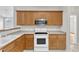 Well-equipped kitchen with stainless steel appliances, oak cabinetry, and efficient layout for cooking and dining at 103 Kylie Savannah Ct, Cary, NC 27511