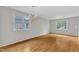 Open living room featuring hardwood floors, large windows and chandelier at 103 Kylie Savannah Ct, Cary, NC 27511