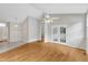 Bright living room featuring hardwood floors and a ceiling fan with doors leading to the outside at 103 Kylie Savannah Ct, Cary, NC 27511
